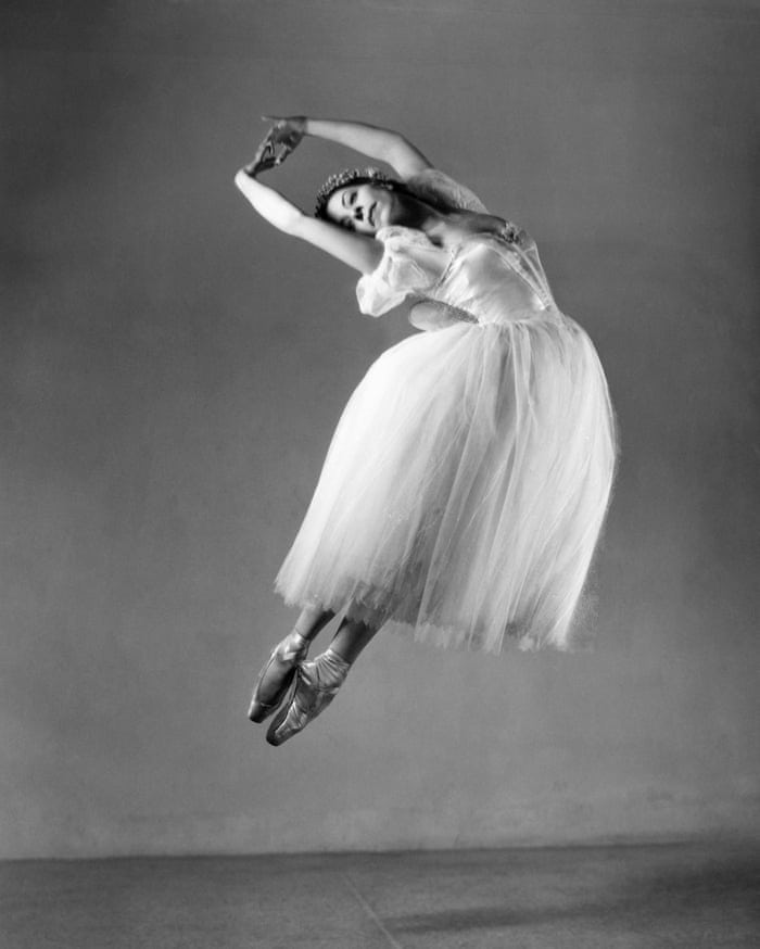 Elegant ballet dancer in tutu performing airborne dance pose, showcasing grace and artistry.