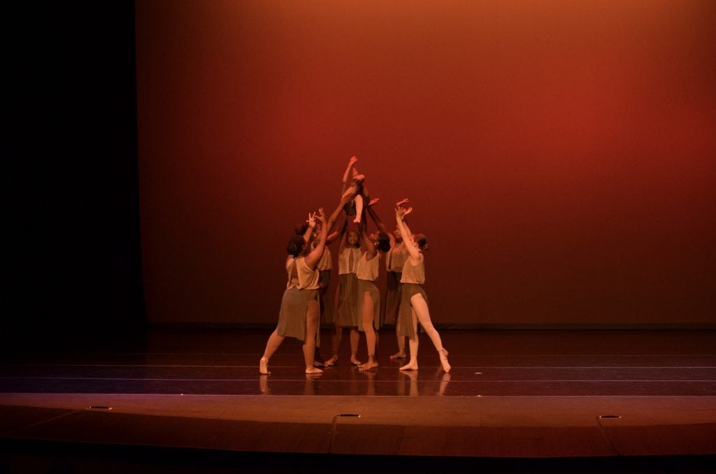 Elegant dance performance on stage at AbunDance, showcasing contemporary choreography and artistic expression.