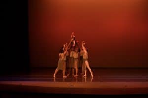 Elegant dance performance on stage at AbunDance, showcasing contemporary choreography and artistic expression.