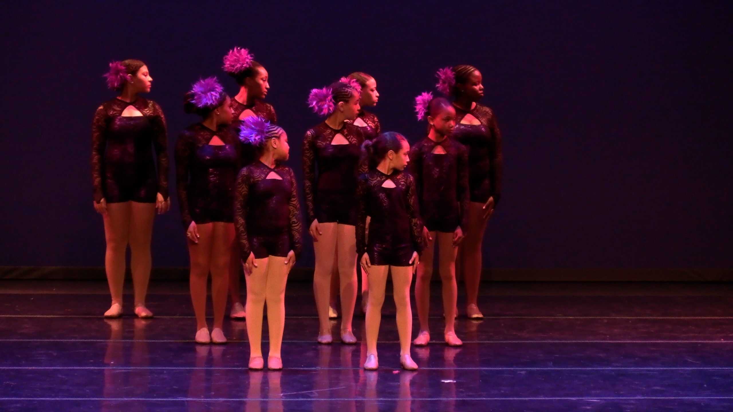 Vibrant dance performance by young girls in black lace costumes at AbunDance studio.