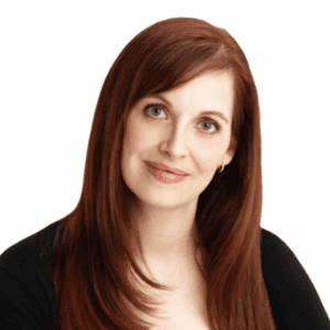 Red-haired woman smiling, headshot for AbunDance wellness program.